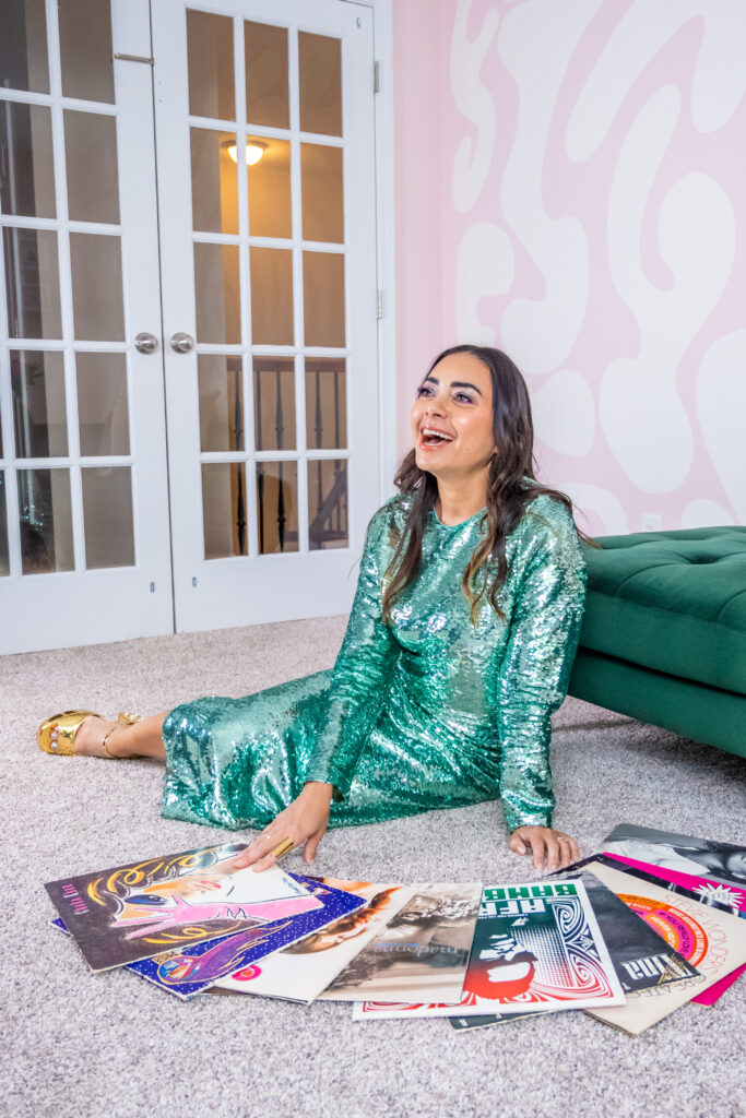 Andrea Serrano sits surrounded by vinyl records in her Charleston home, photographed by Jennifer Mary Collective.