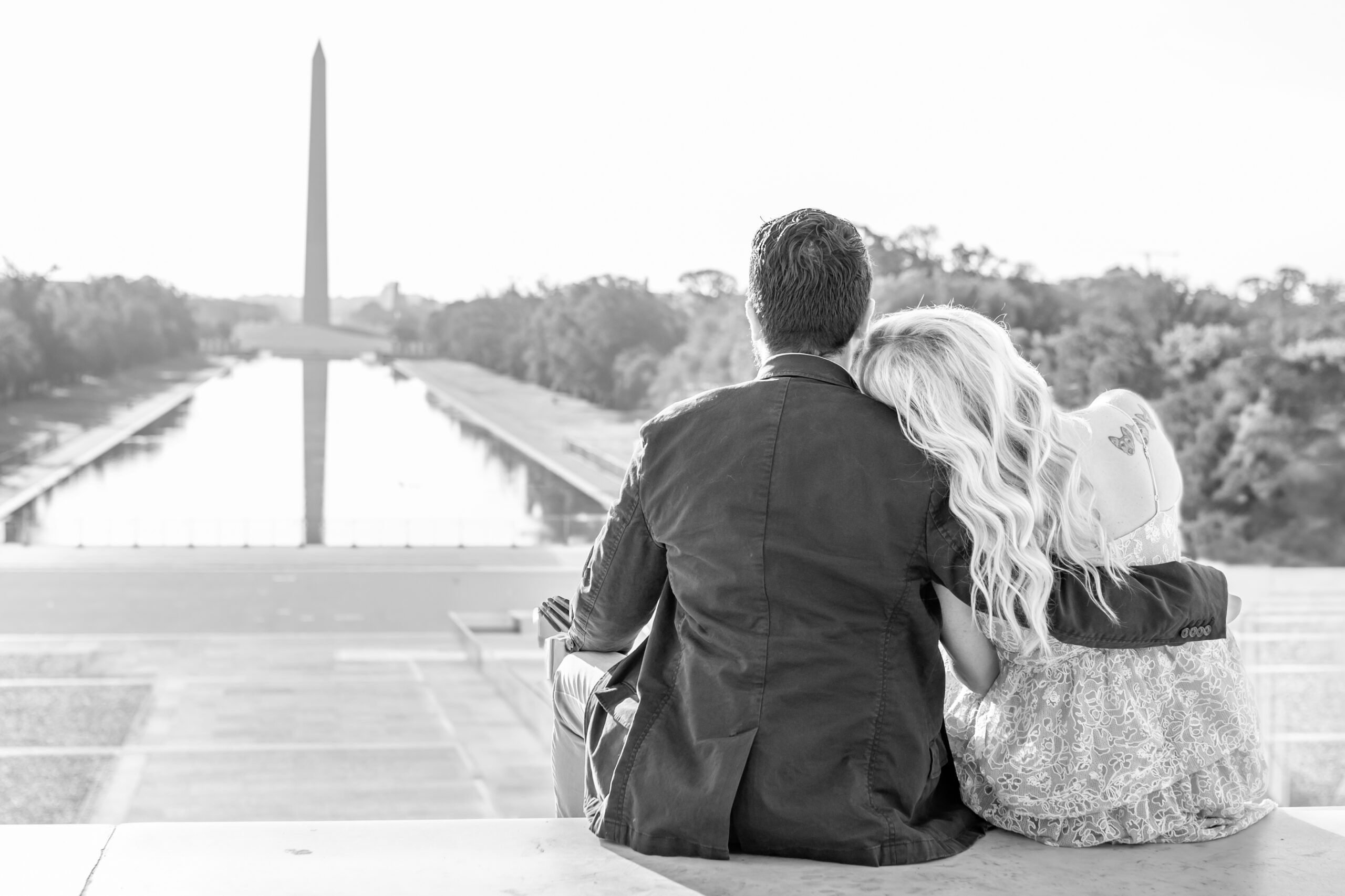 Couple seated on the steps of the Lincoln Memorial looking toward the Washington Monument during their Washington DC editorial session.