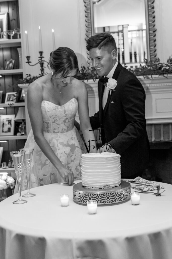 Bride and groom cutting their wedding cake together.