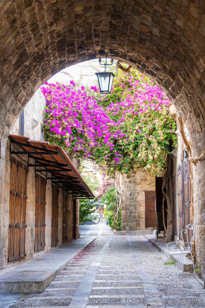 Stone archway with bougainvillea flowers in old city street Lebanon