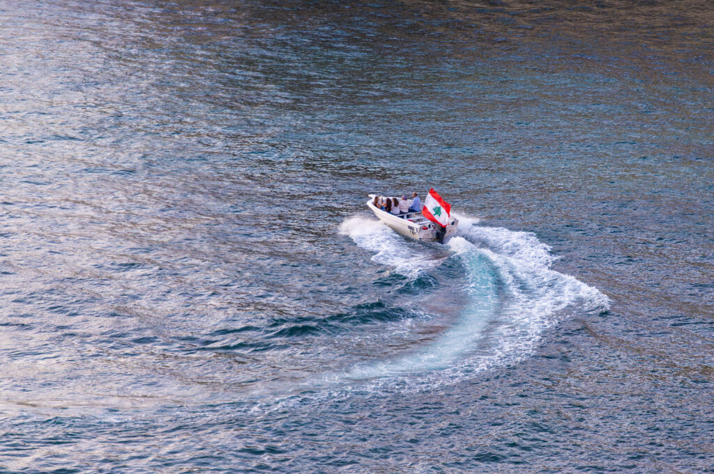 Boat carrying Lebanese flag on the Mediterranean Sea near Beirut Lebanon